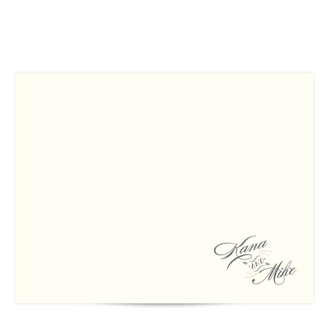 ivory flat card with charcoal grey cursive script in the bottom right hand corner